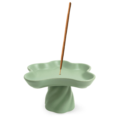 The OCTAEVO Templo Incense Holder is a green, flower-shaped stoneware piece that also works as a decorative catchall.