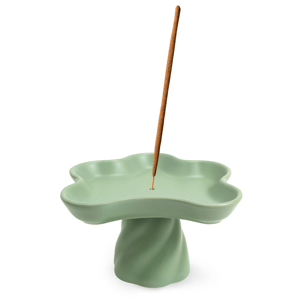 The OCTAEVO Templo Incense Holder is a green, flower-shaped stoneware piece that also works as a decorative catchall.