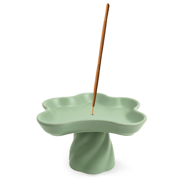 The OCTAEVO Templo Incense Holder is a green, flower-shaped stoneware piece that also works as a decorative catchall.