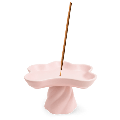 The Templo Incense Holder by OCTAEVO is a pink, flower-shaped stoneware piece for upright incense sticks.