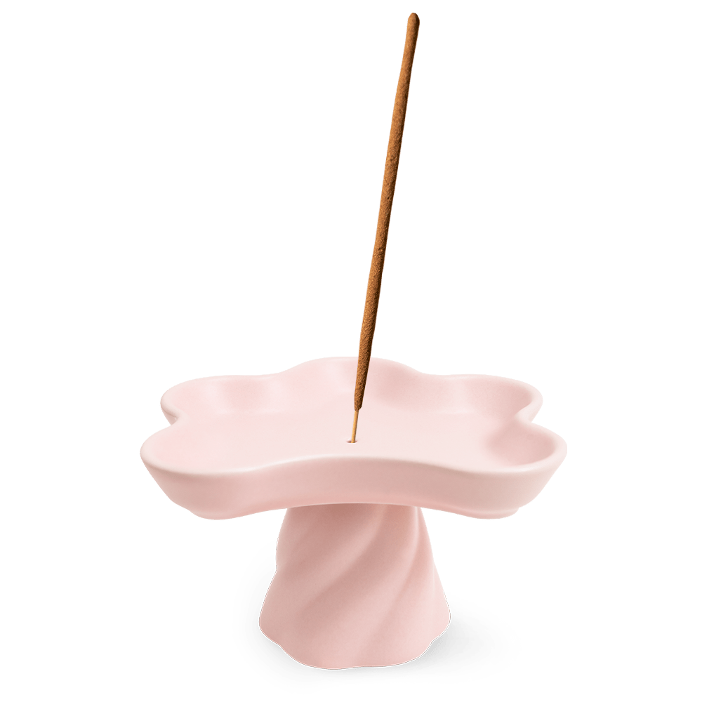 The Templo Incense Holder by OCTAEVO is a pink, flower-shaped stoneware piece for upright incense sticks.