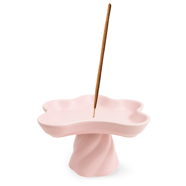 The Templo Incense Holder by OCTAEVO is a pink, flower-shaped stoneware piece for upright incense sticks.