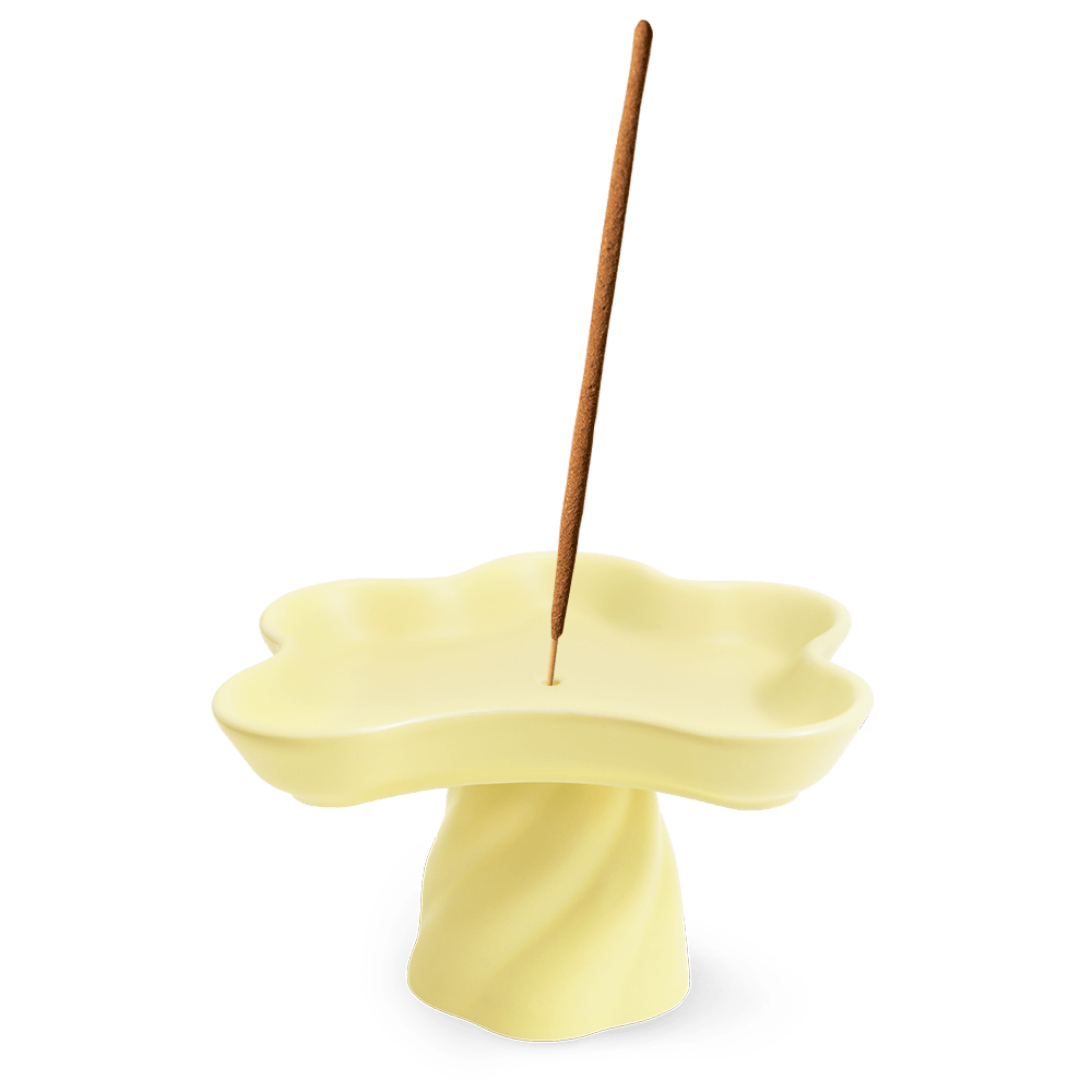 OCTAEVO Templo Incense Holder: handmade stoneware, pale yellow flower shape, holds an incense stick in the center.