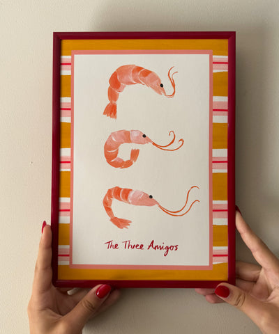 "The Three Amigos" playful art print of three prawns framed by a bold striped border beiing held