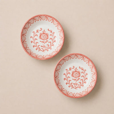Two decorative plates with floral patterns on a beige background