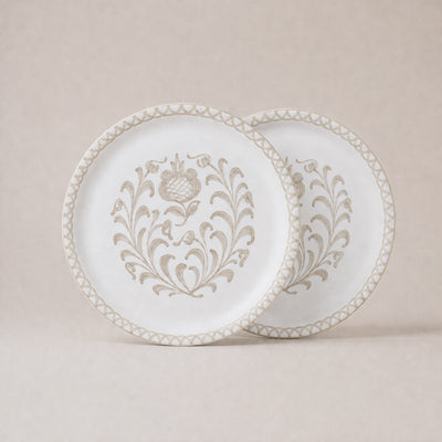 Two decorative plates with intricate patterns on a beige background