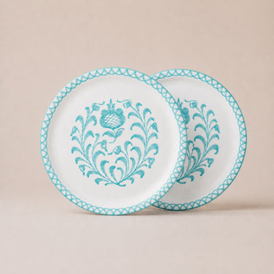 Two white plates with blue floral patterns on a beige background
