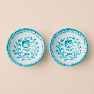 Two ceramic bowls with floral patterns on a beige background