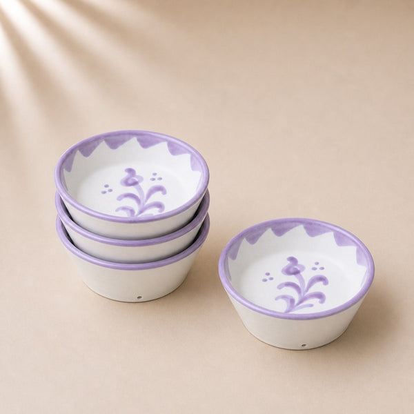 Set of ceramic bowls with purple floral patterns on a beige background