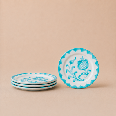 Set of decorative plates with blue and white patterns on a beige background