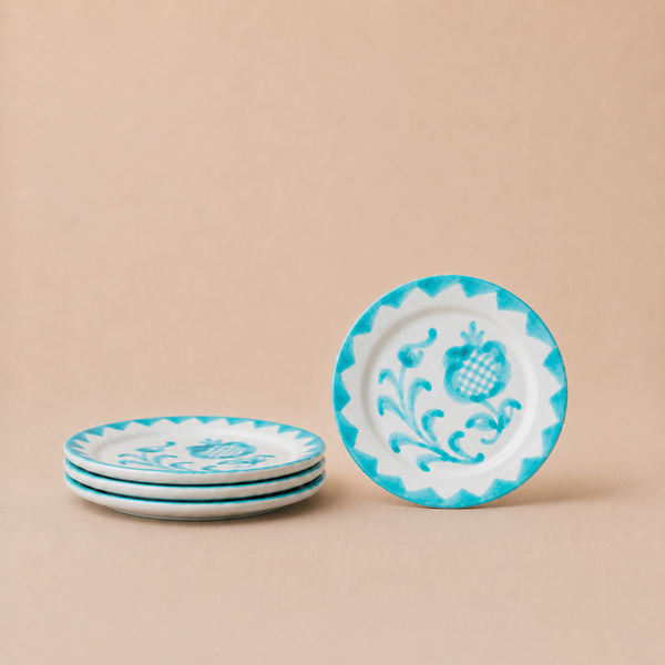 Set of decorative plates with blue and white patterns on a beige background