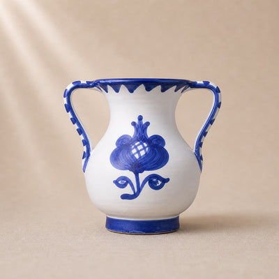 Ceramic vase with blue floral design on a beige background