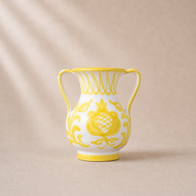 Decorative vase with yellow floral patterns on a beige background