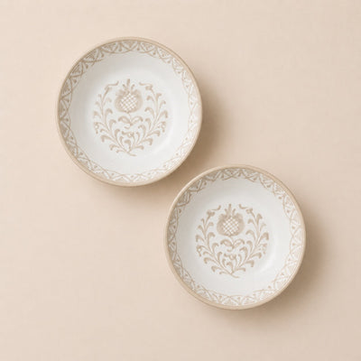 Two decorative plates with intricate patterns on a beige background