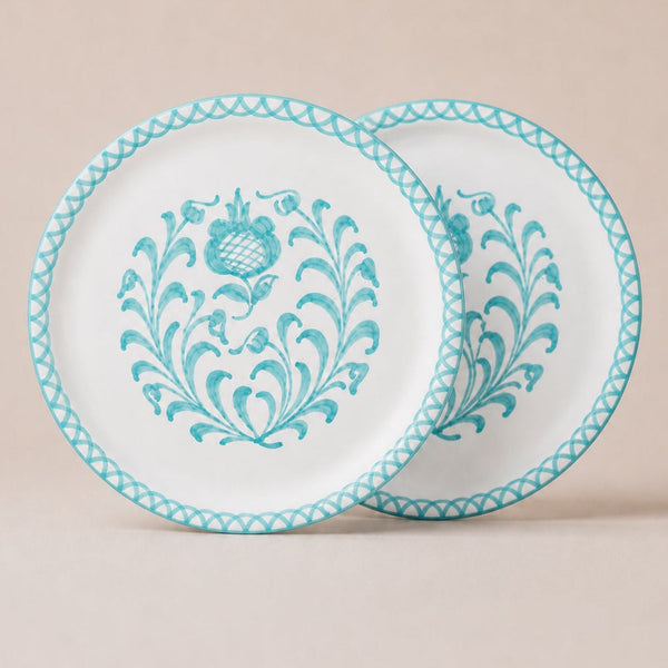 Two traditional dinner plates with blue floral patterns on a beige background