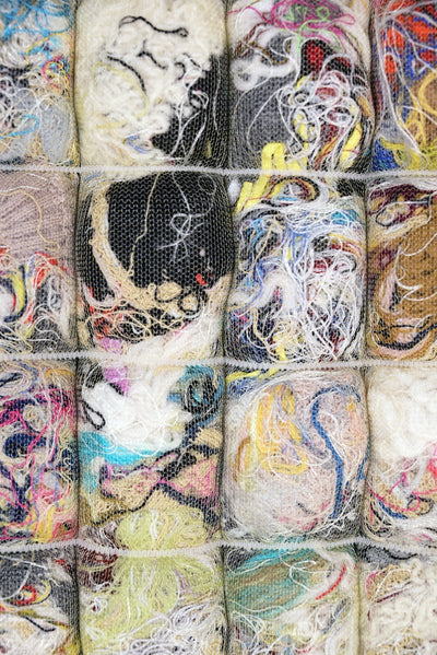 detail of knit seat cushion with transparent cover filled with upcycled materials
