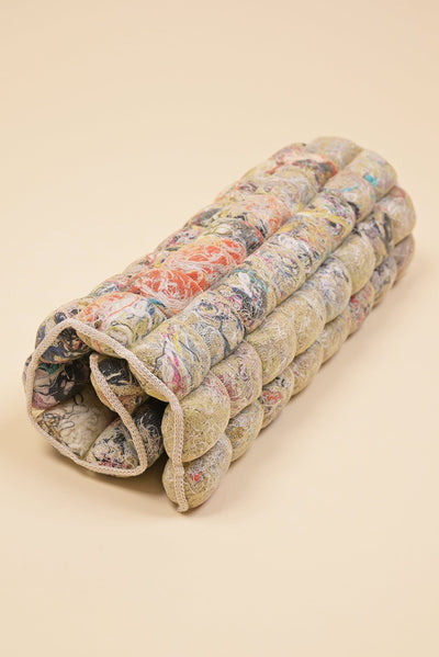 rolled up knit seat cushion with transparent cover filled with upcycled materials