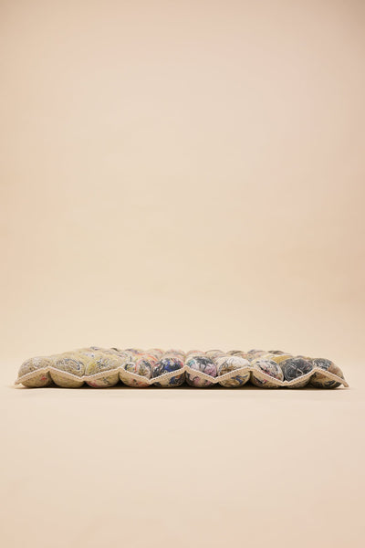 side view of knit seat cushion with transparent cover filled with upcycled materials