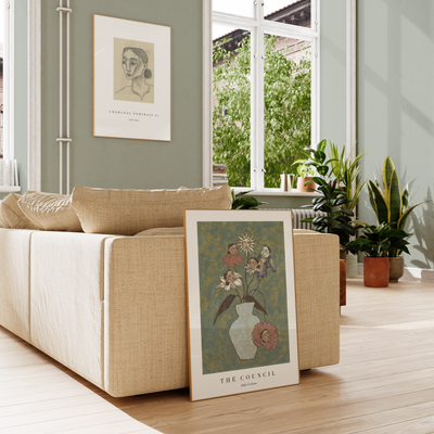 two prints in a livingroom with a sofa and green walls