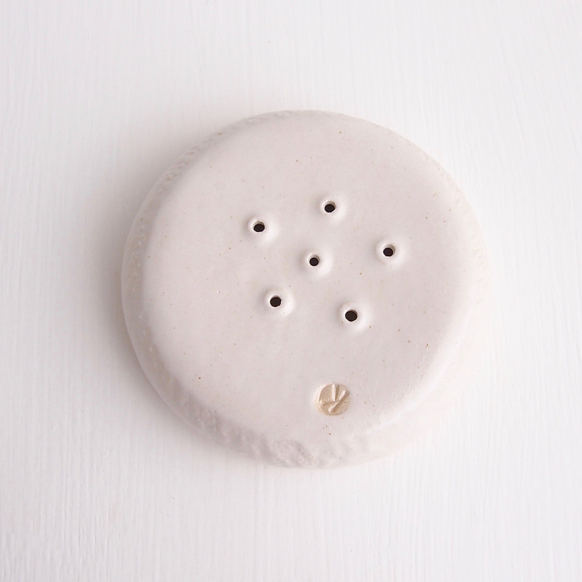 underside white satin pottery soap dish