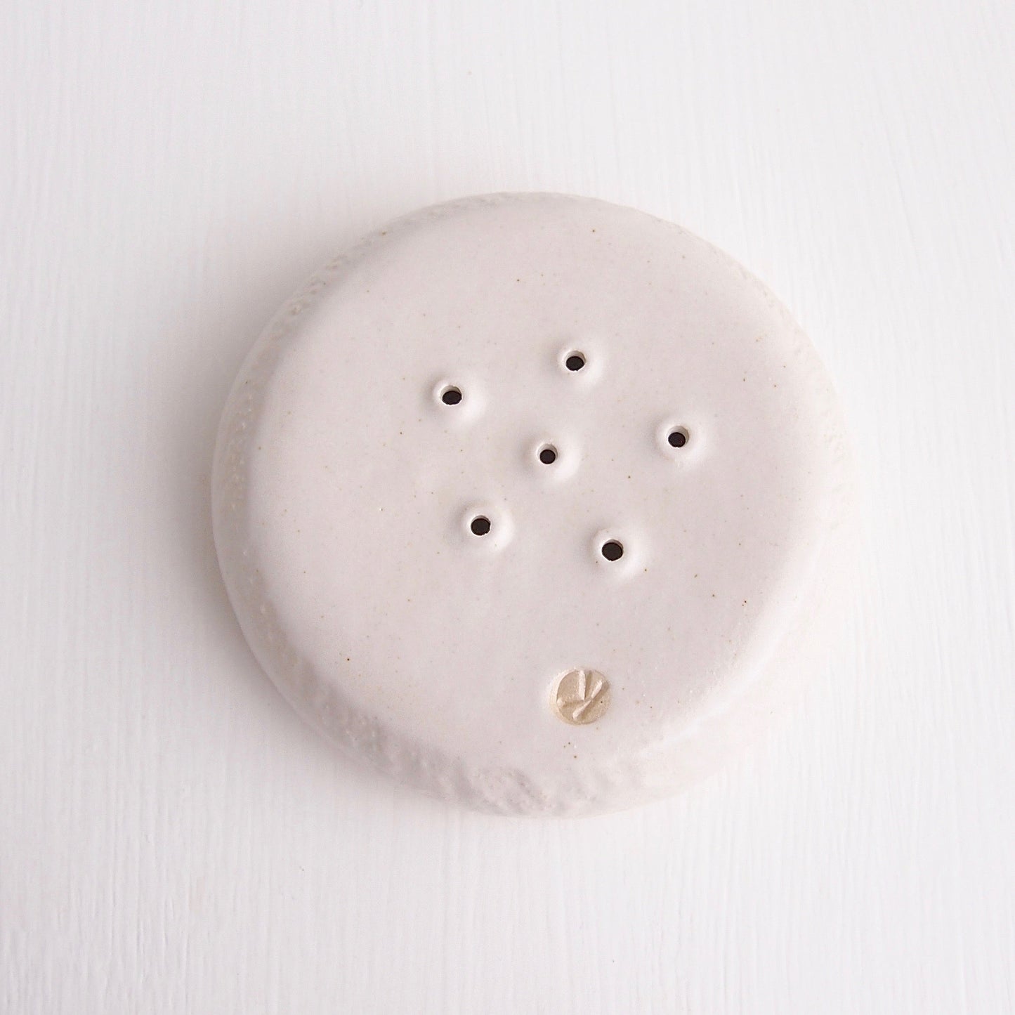 underside white satin pottery soap dish
