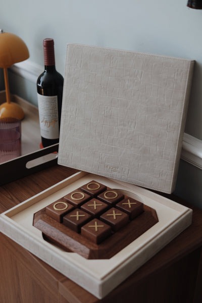 Vinidec solid walnut wood noughts and crosses game set with brass inlay, displayed in an open cream croc-embossed leather presentation case