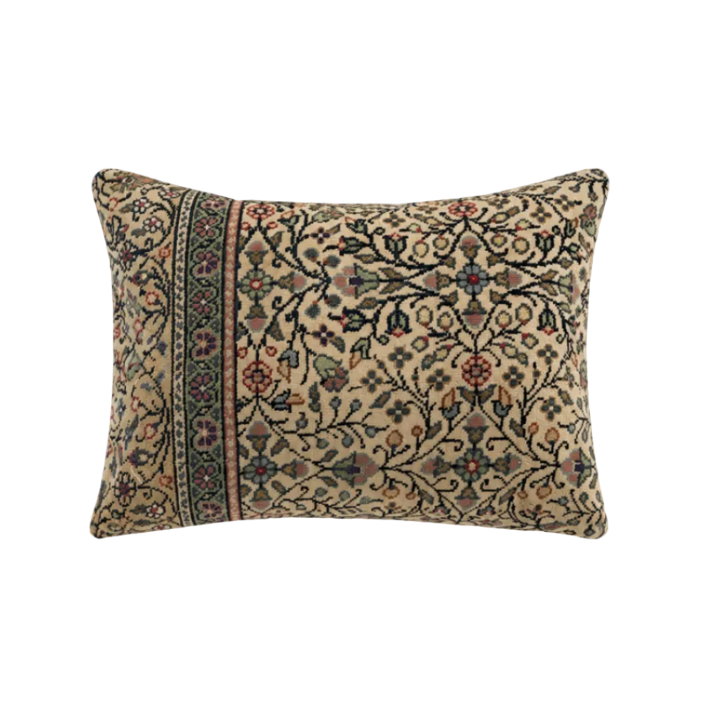 vintage kilim bolster cushion cover in greens and reds on a cream background
