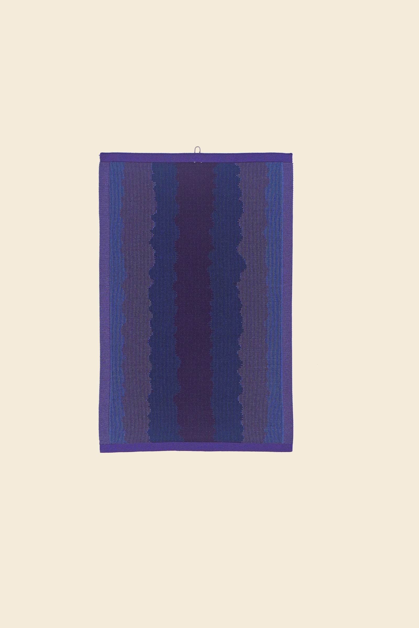 front view of purple knit organic cotton kitchen towel with wavy pattern