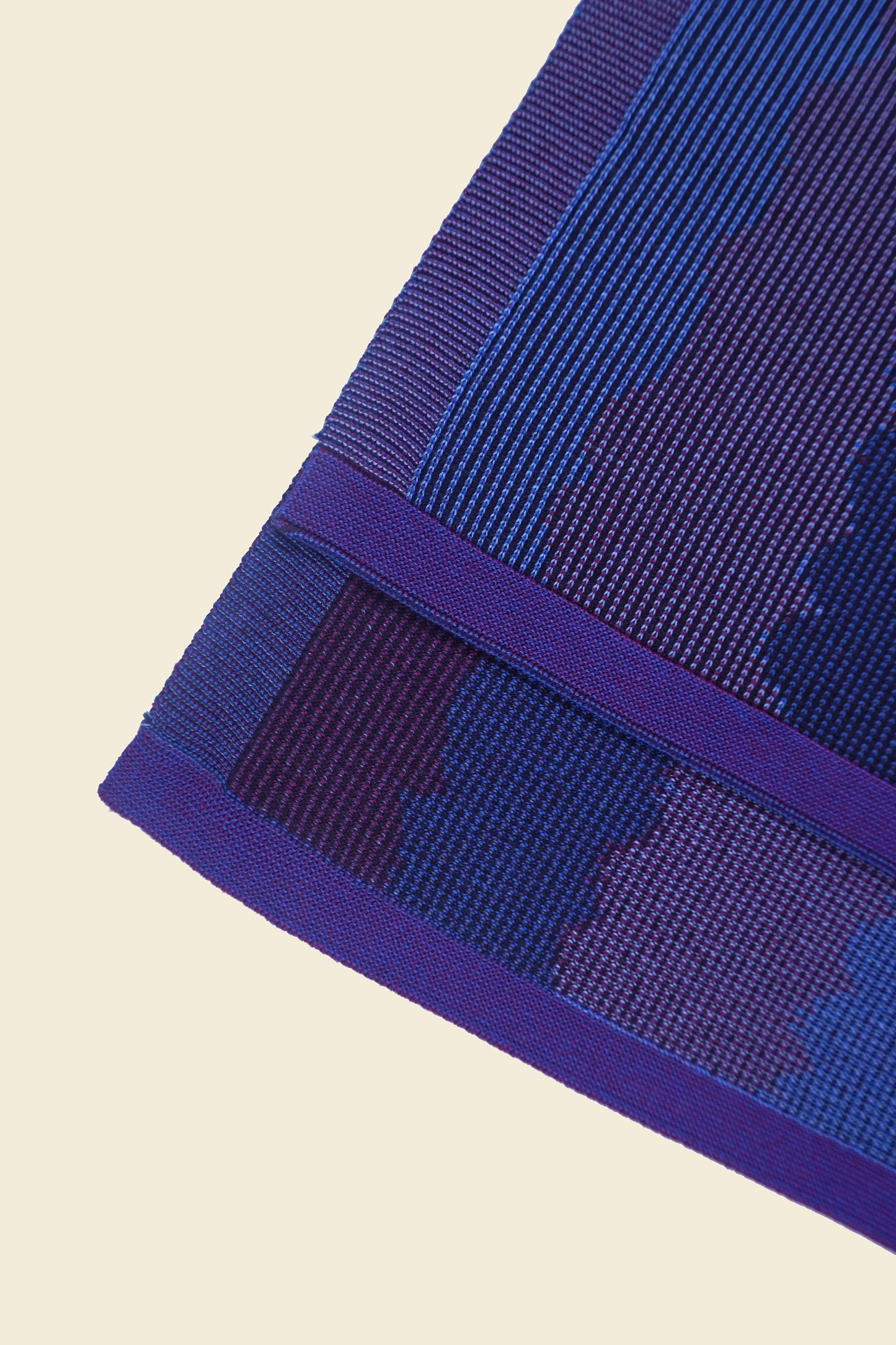 corner detail of purple knit organic cotton kitchen towel set with wavy pattern