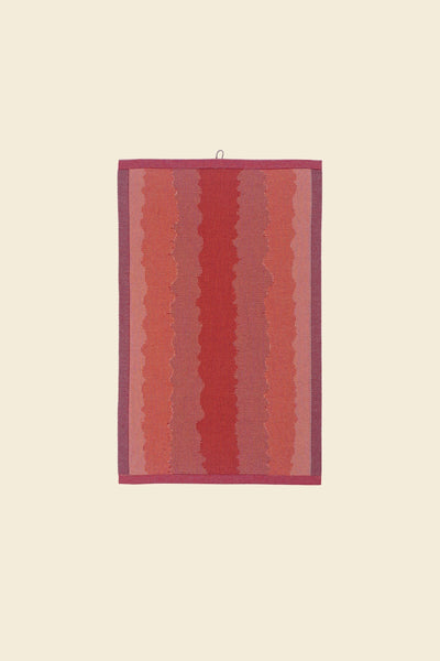 front view of red knit organic cotton kitchen towel with wavy pattern