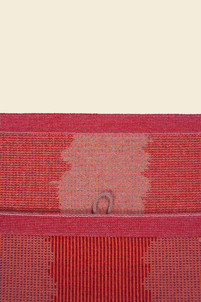 top detail of red knit organic cotton kitchen towel with wavy pattern