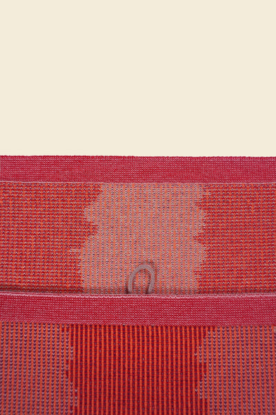 top detail of red knit organic cotton kitchen towel with wavy pattern