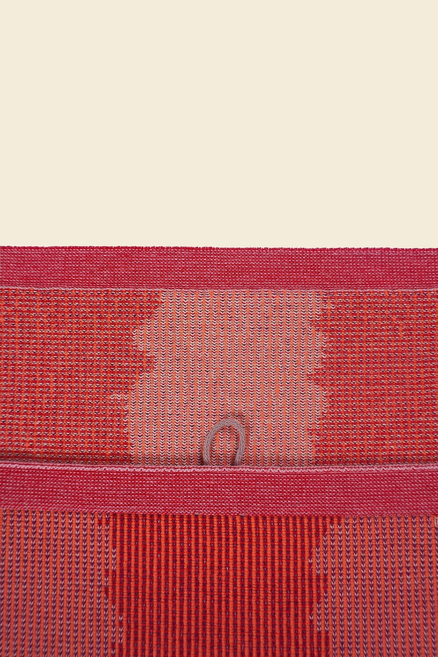 top detail of red knit organic cotton kitchen towel with wavy pattern