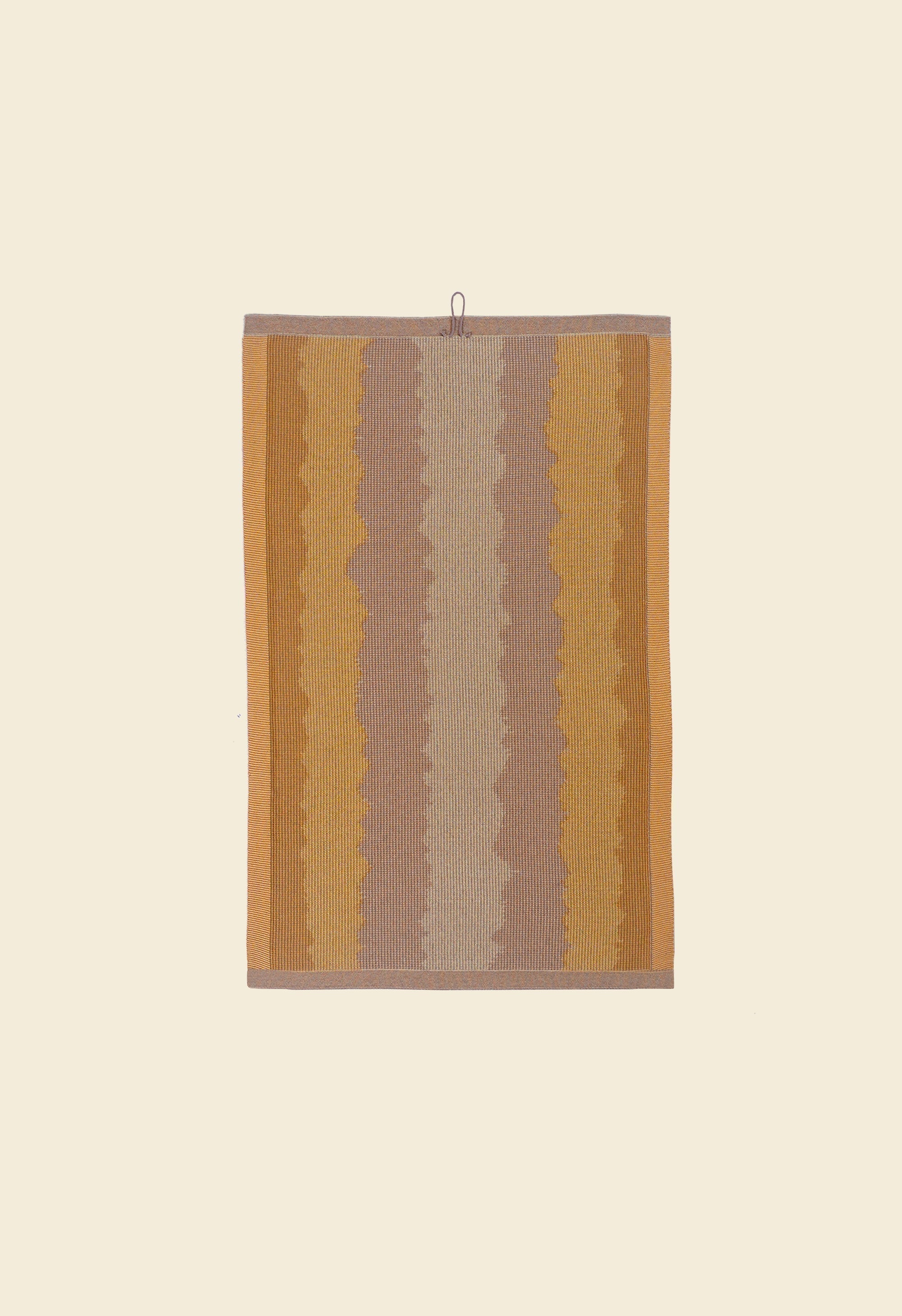 back side of yellow knit organic cotton kitchen towel with wavy pattern