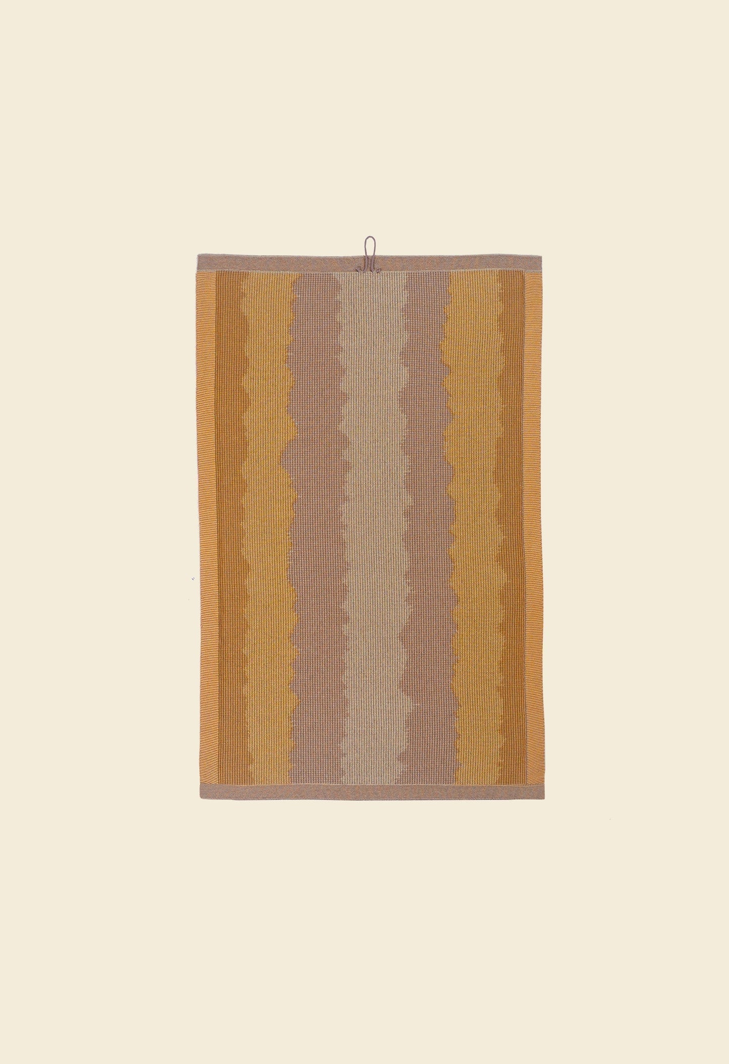 back side of yellow knit organic cotton kitchen towel with wavy pattern
