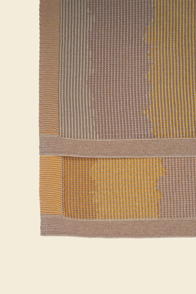 corner detail of yellow knit organic cotton kitchen towel with wavy pattern