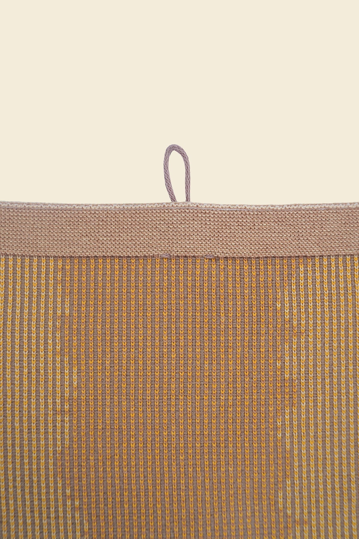 top detail of yellow knit organic cotton kitchen towel with wavy pattern
