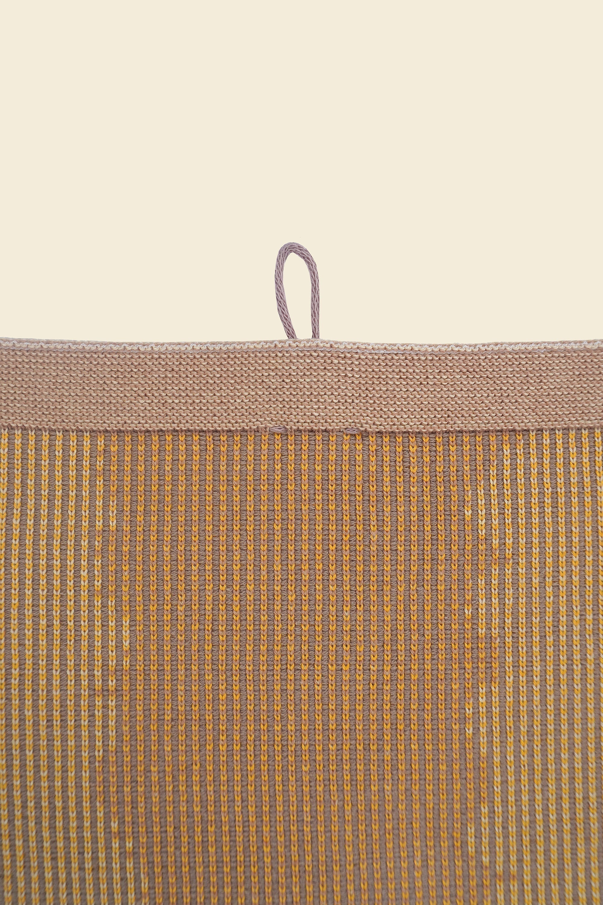 top detail of yellow knit organic cotton kitchen towel with wavy pattern