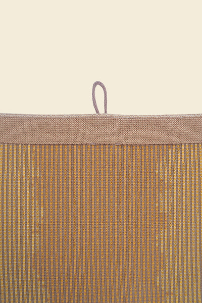 top detail of yellow knit organic cotton kitchen towel with wavy pattern
