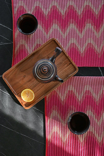 top detail view of red/yellow knit table mat in organic cotton and viscose with wavy pattern