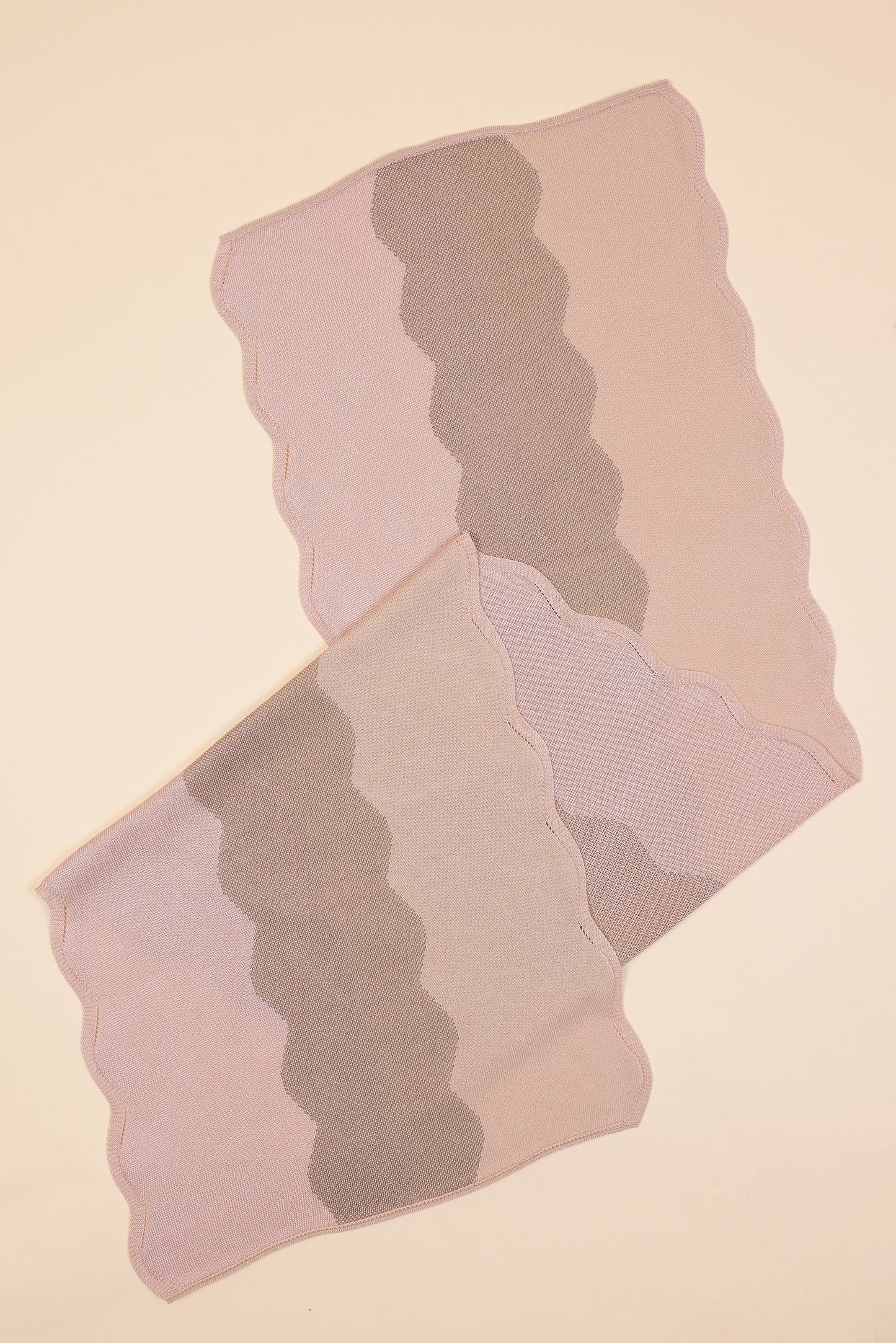 close-up folded view of wavy knit organic cotton table runner in pink  