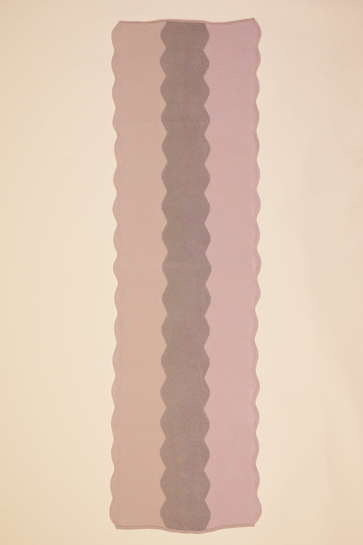top view of wavy knit organic cotton table runner in pink  