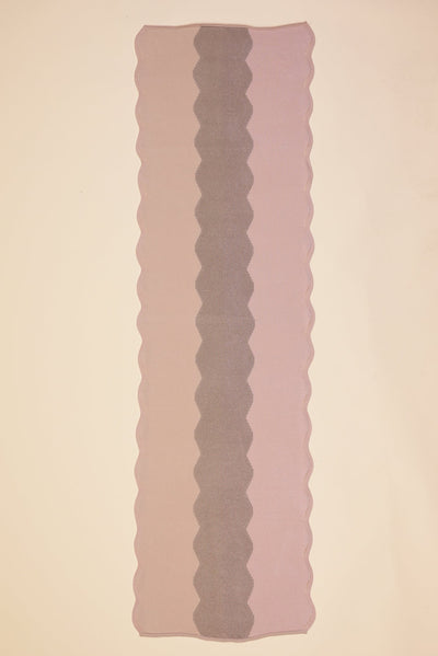 top view of wavy knit organic cotton table runner in pink  