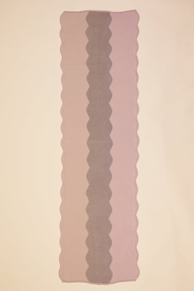 top view of wavy knit organic cotton table runner in pink  