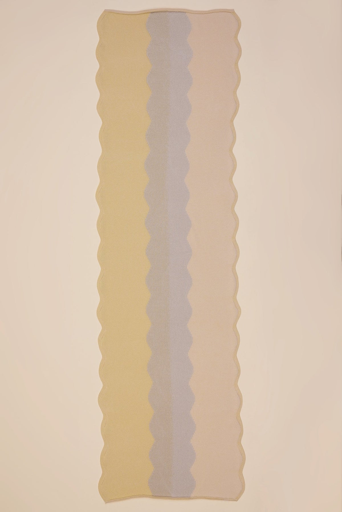 top view of wavy knit organic cotton table runner in yellow
