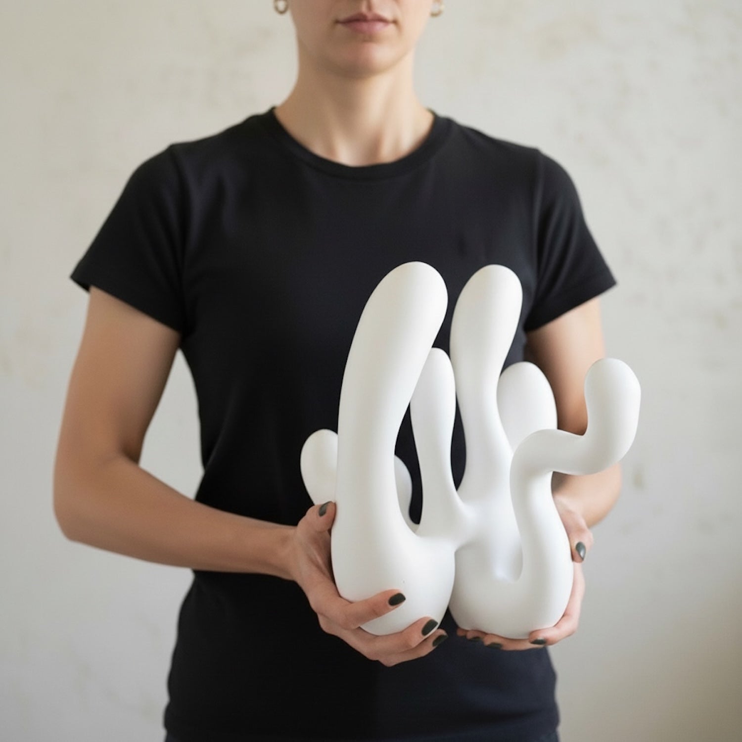 White sculpture and candleholder in girls hands for scale