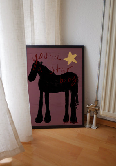 aubergine purple modern western art print featuring a horse and star in chartreuse and aubergine. Oil painting–style modern folk wall art by KunstbyStephie. framed poster leaning on floor