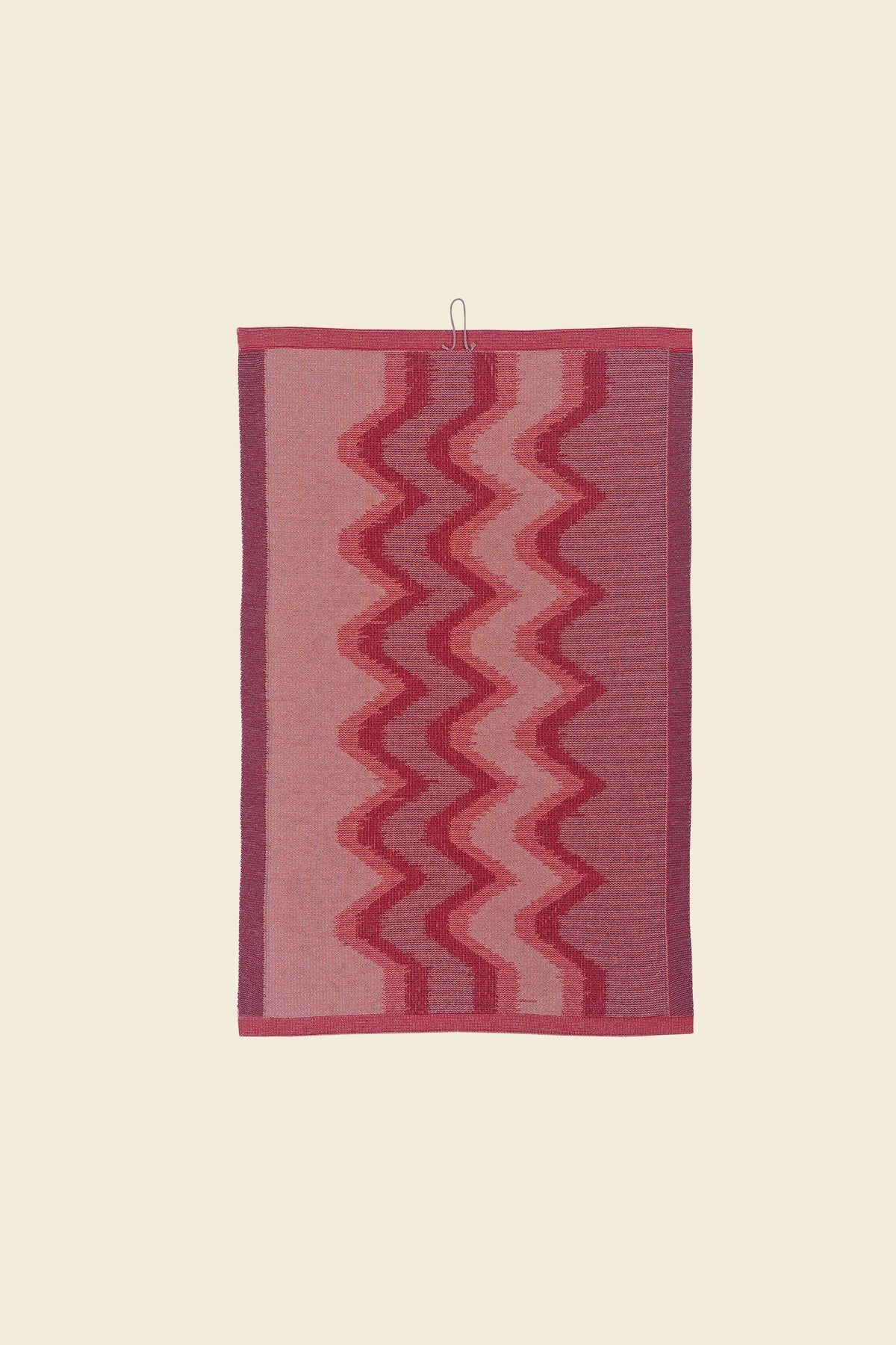 back side of red knit organic cotton kitchen towel with zig zag pattern