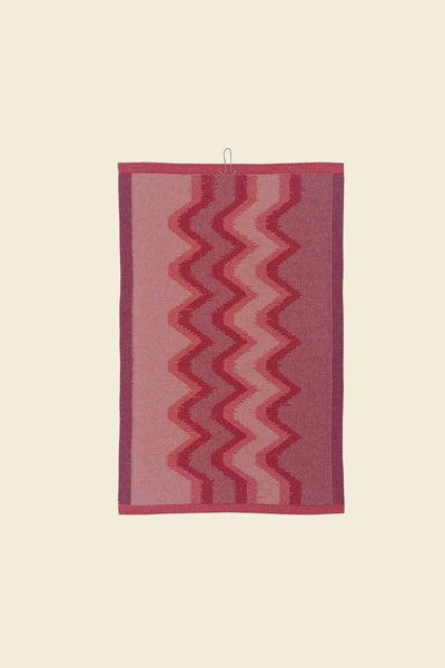 back side of red knit organic cotton kitchen towel with zig zag pattern