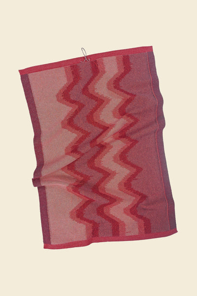back side of red knit organic cotton kitchen towel with zig zag pattern